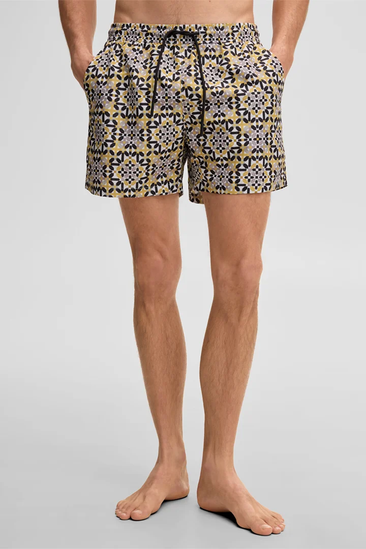 Leads to product detail page "Lago Swimming Shorts in a Mustard Yellow Pattern"
