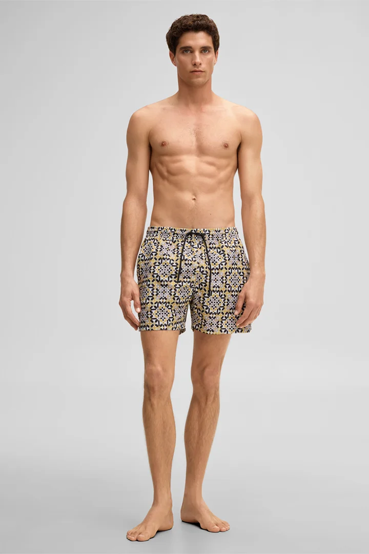 Leads to product detail page "Lago Swimming Shorts in a Mustard Yellow Pattern"